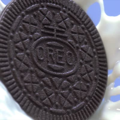 Oreo Thins cookie in a splash of milk.