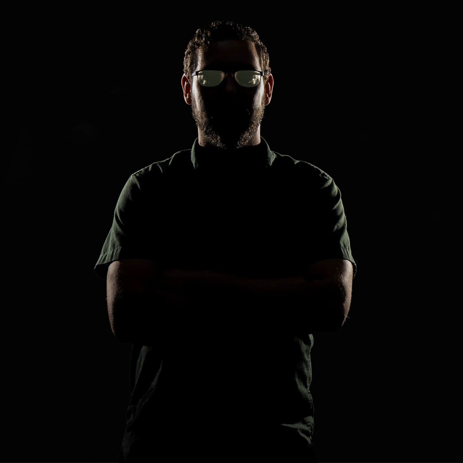 Portrait of Deven James in dramatic low light.